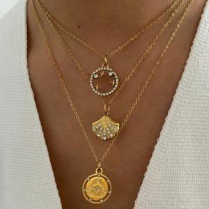 Three-layer gold necklace with star ring, shell pendant, and vintage relief medallion
