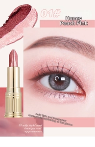 Detail of peach pink dual-tone eyeshadow stick with shimmer finish and gold carved tube
