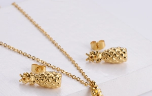 Detailed view of gold plated pineapple jewelry set with necklace and stud earrings