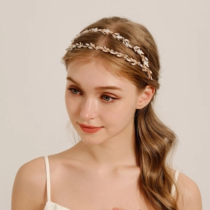 Detailed view of handmade Baroque headband featuring gold leaves and white pearls for brides