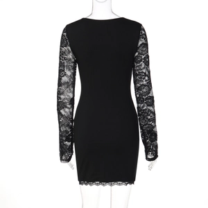 Detailed back view of slim fit dress featuring sheer lace sleeves and textured fabric