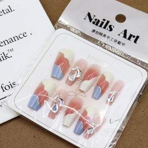 Salt blue and cream press-on nails in coffin shape with rhinestones and droplets