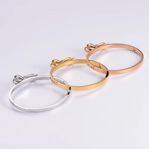 Polished stainless steel bow cuff bracelet in silver, gold, and rose gold finishes