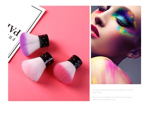 Detail of diamond-studded handle makeup brushes with purple and pink gradient bristles