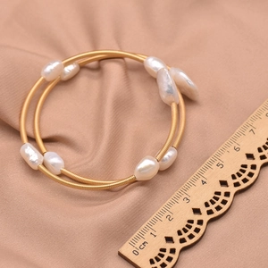Close-up of handmade baroque pearl gold wrap bracelet with a ruler showing 5.5cm size