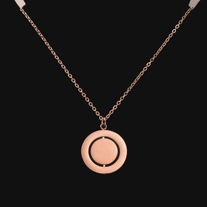 Macro detail of rose gold rotating double layer geometric circular pendant necklace