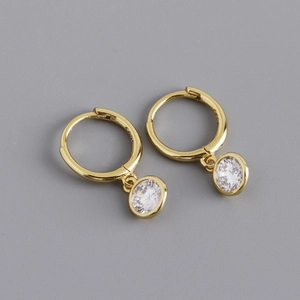Close-up of S925 sterling silver stamp on golden hoop earrings with clear cubic zirconia