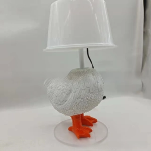 Detail of chicken-shaped resin lamp featuring realistic feather texture and a sturdy base