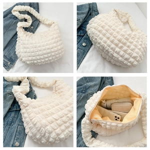 Detailed view of cream bubble texture tote bag showing interior lining and large capacity