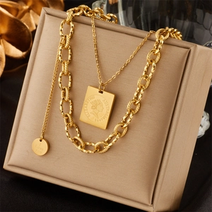 Detail of gold double-layer necklace with Elizabeth II coin and I Love You pendant