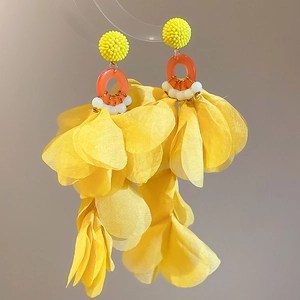 Detail of yellow tulle flower tassel earrings with intricate seed bead woven studs