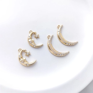 Detailed view of 14K gold plated moon pendants with inlaid zircon and celestial designs