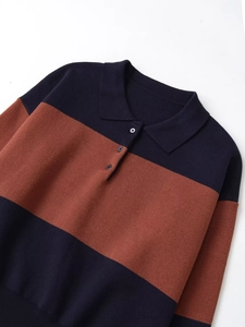Detail of long sleeve striped polo knit sweater with buttoned collar and ribbed cuffs