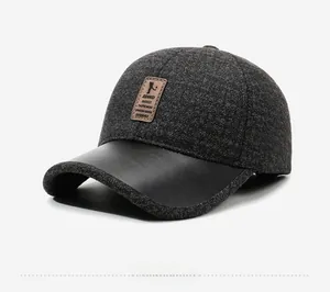 Detail of wool texture and leather brim on grey winter baseball cap with brand patch