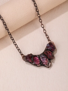Detailed macro view of vintage gothic bat pendant with natural raw purple amethyst stones