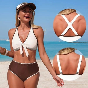 White halter bikini set with brown wavy trim and high-waisted bottoms on beach