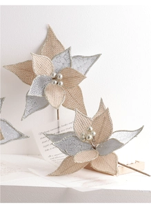 Close-up of handmade linen Christmas flowers with silver pearls and sequin textures
