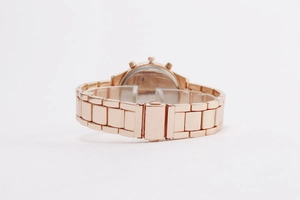Detail view of the rose gold metal watch band links and secure fold-over clasp