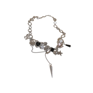 Punk style silver necklace with butterfly, heart, and pearl charms on white background