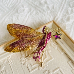Elegant fairy brooch with gradient enamel wings and star pendant in a wooden frame
