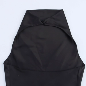 Detailed close-up of a black satin halter dress showing its shiny texture and unique cut
