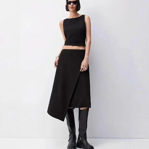 Detail showing high-waist asymmetric slit skirt and sleeveless crop top in black