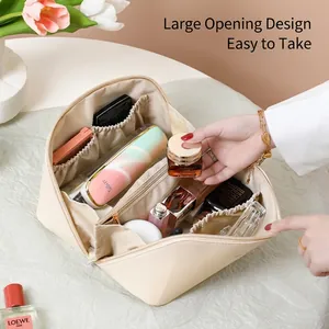 Large cream leather makeup bag with wide opening and multiple storage compartments