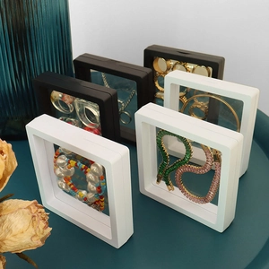 Black and white PE film floating jewelry display boxes with rings and necklaces