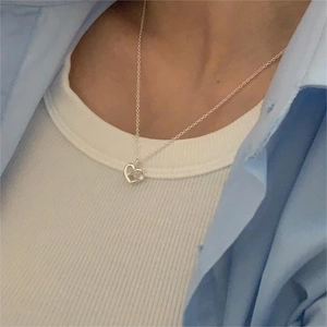 Detailed close-up of 925 sterling silver heart pendant necklace with a small sparkling diamond