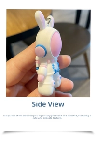 Side view of white and pink astronaut bunny keychain with metallic ring attachment