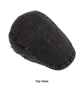 Top view of dark grey washed denim newsboy cap showing detailed stitching and fabric texture