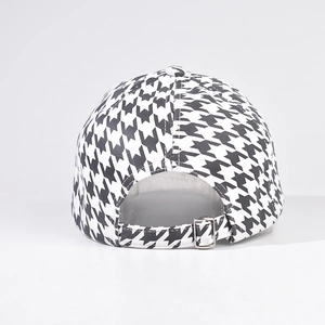 Adjustable silver metal buckle and houndstooth fabric detail on back of baseball cap