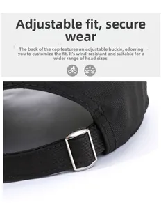 Detail of adjustable silver metal buckle and woven strap on a black cotton baseball cap