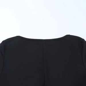 Detailed view of the round neckline and shoulder texture on a black evening gown