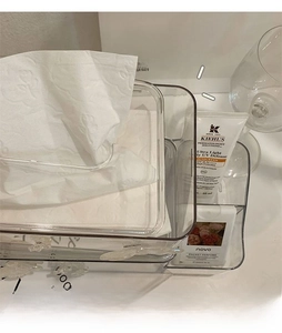 Clear plastic tissue box with side compartments for skincare and perfume storage