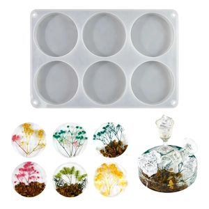 Detailed view of 6-cavity round silicone mold with DIY resin coasters featuring dried flowers