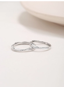 Detailed macro view of S925 sterling silver Mobius rings with pavé cubic zirconia inlay