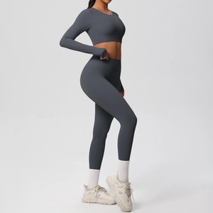 Detail of grey seamless long sleeve crop top and high waist leggings for yoga