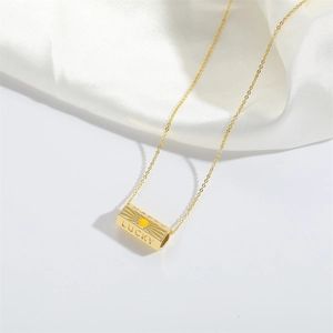 Golden Lucky Happy pendant necklace with yellow heart and zircon on white silk background