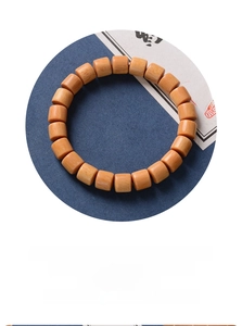 Macro detail of natural wood barrel beads showcasing rich texture and zen craftsmanship