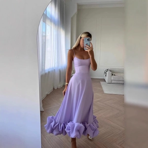 Elegant purple A-line evening dress with spaghetti straps and voluminous ruffled hemline