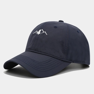 Close-up of high-density white mountain embroidery on a navy quick-dry baseball cap