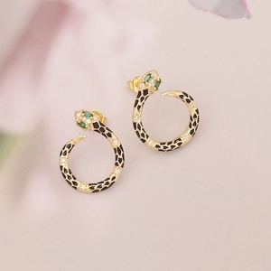 Golden snake stud earrings with green gemstones and black enamel inlay design