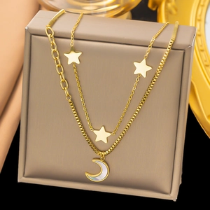 Detailed view of a gold-tone layered necklace with star charms and a crescent moon pendant