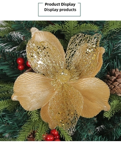 Detail of gold glitter Christmas flower with hollow mesh petals on festive tree branch