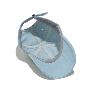 Internal view of denim baseball cap with grey sweatband and metal adjustment buckle