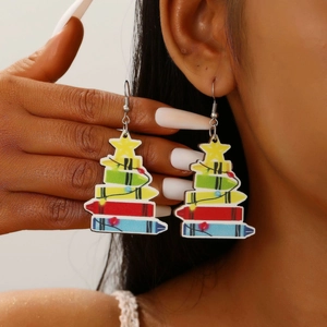 Macro shot of colorful wooden Christmas tree earrings featuring crayon-stack design on model