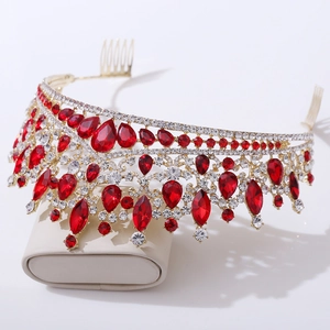 Detail of golden bridal tiara comb with red teardrop rhinestones and clear crystals