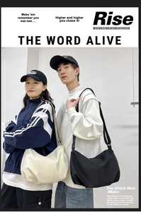 Close-up of minimalist nylon dumpling bag in beige and black shown in studio setup