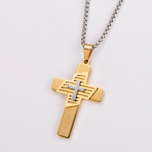 Detail of two-tone gold and silver cross necklace with geometric texture on white background